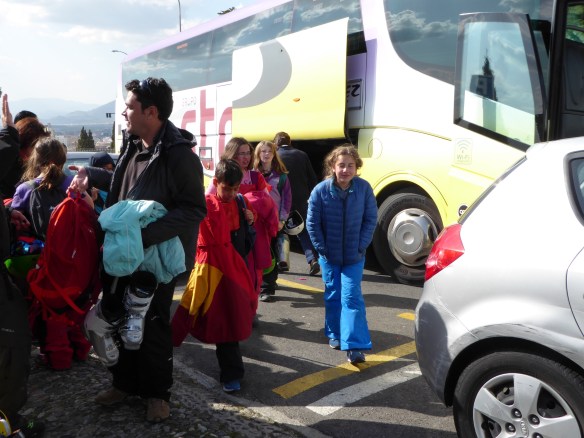 A. rode this bus, carried her helmet and ski boots, lunch, water bottle, sun screen, and snack and never stopped smiling.